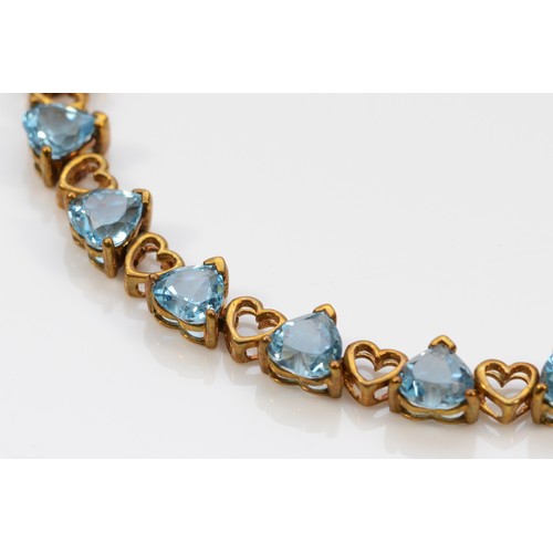 337 - A 9ct gold heart shaped blue gemstone bracelet, 18cm, 8.9g