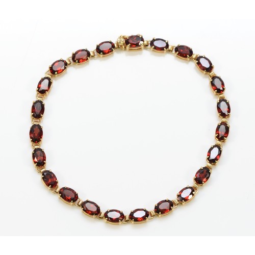 343 - A 9ct gold garnet bracelet, 18cm, 6.8g