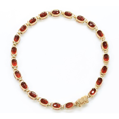 343 - A 9ct gold garnet bracelet, 18cm, 6.8g