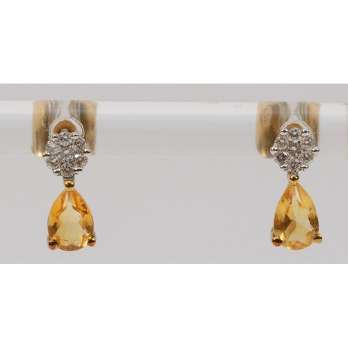 351 - A pair of 9ct gold citrine and diamond earrings with scroll backs, 1g