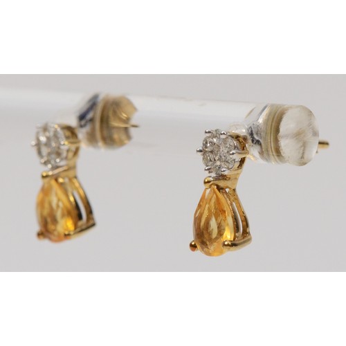 351 - A pair of 9ct gold citrine and diamond earrings with scroll backs, 1g