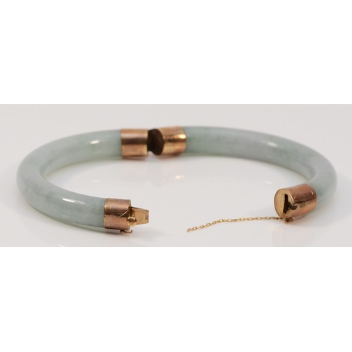 355 - A 9ct gold jade bangle, 60mm internal diameter, 43g