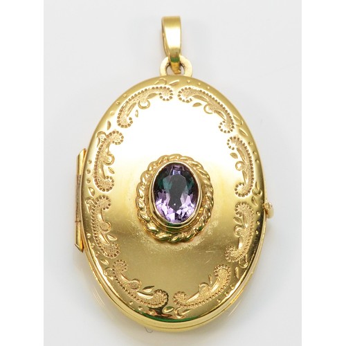 370 - A 9ct gold locket pendant with a purple gemstone to the front, 27mm length, 4g