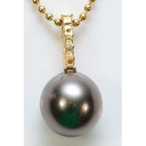 500 - An 18ct gold cultured pearl and brilliant cut diamond pendant with a chain, 17mm pendant drop, 4.3g