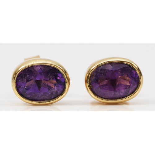 505 - A pair of 9ct gold amethyst earrings with scroll backs, 8mm x 5mm, 2.1g