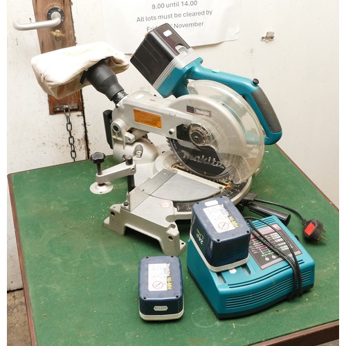 18 - A Makita 24V cordless chop saw, model BLS820, together with three batteries and charger.