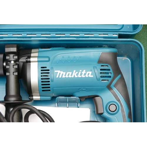 27 - A boxed Makita 240v hammer drill, model HP1631, appears to be unused.