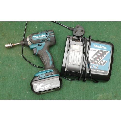 30 - A Makita impact driver, model No. DTD 152, with battery and charger.