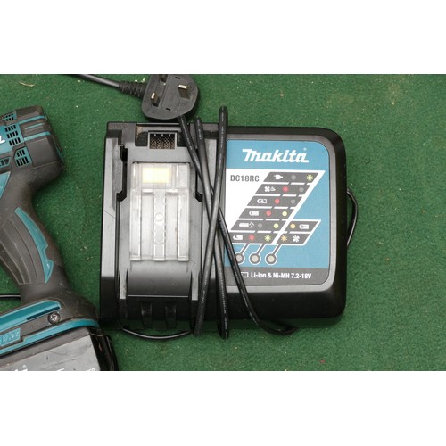 30 - A Makita impact driver, model No. DTD 152, with battery and charger.