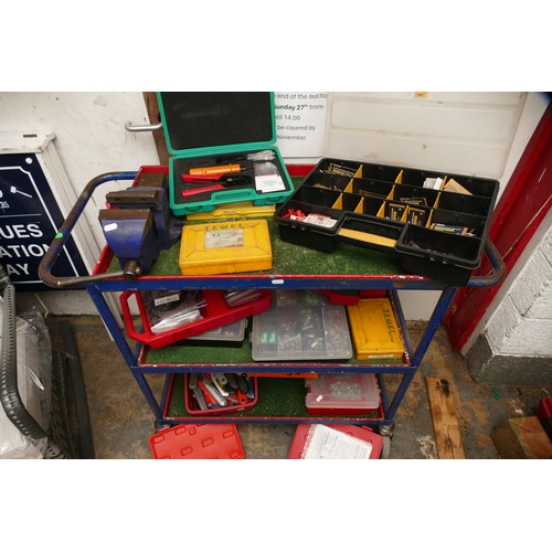 46 - A mechanics rolling three tier trolley with contents which include a Record no. 3 vice, boxes of har... 