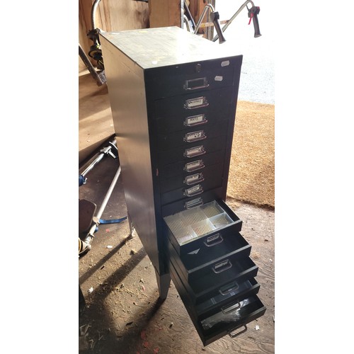 82 - Metal free standing metal storage unit with pull out drawers containing a quantity of engineering co... 