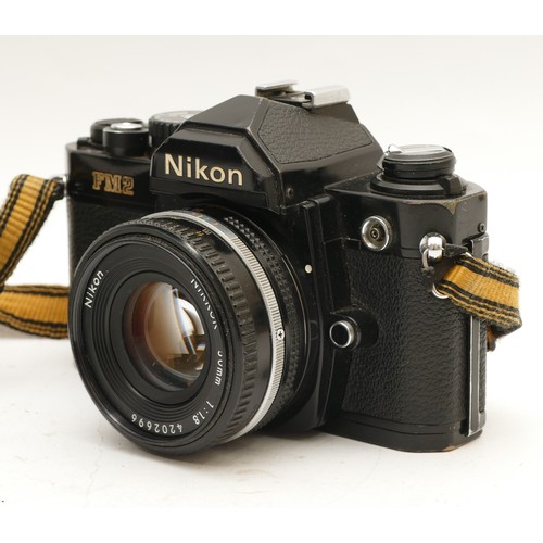 211 - A Nikon FM2 film camera, with a Nikon Nikkor f/1.8 50mm lens.