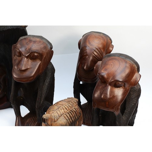 253 - A group of six figural carved hardwood sculptors, to include the three wise monkeys , 25cm tall, two... 