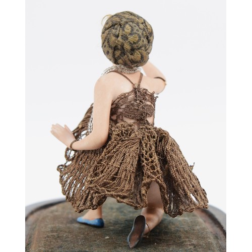 299 - Galluba and Hofmann, a German painted bisque figurine of a kneeling flapper lady holding a rose, c.1... 