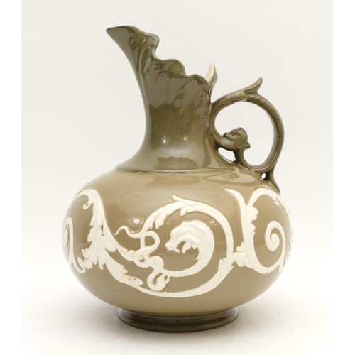 317 - An early twentieth century James Macintyre Washington Faience ewer, with scalloped spout and a raise... 