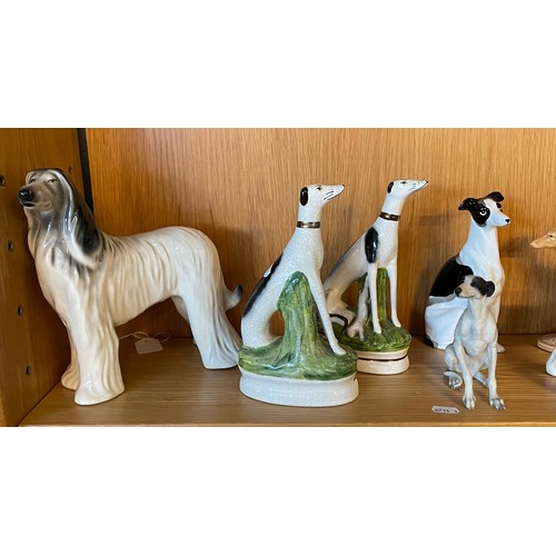 335 - A collection of 20th century ceramic models of dogs, to include two pairs of Staffordshire ware seat... 