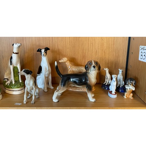 335 - A collection of 20th century ceramic models of dogs, to include two pairs of Staffordshire ware seat... 