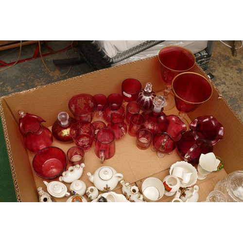 318 - A collection of crested goss ware, a collection of cranberry glass to include glasses, vases and tum... 