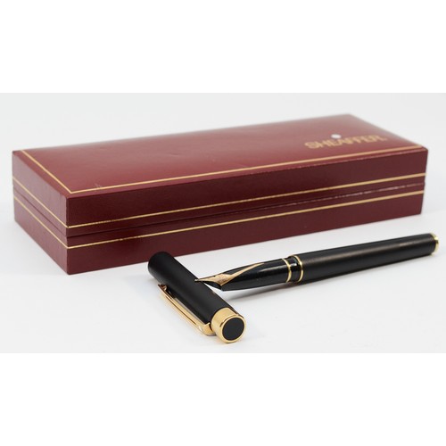 365 - Sheaffer, a black resin squeeze action fountain pen with 14K gold nib, case