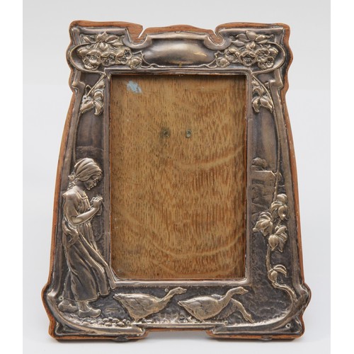 442 - A silver photograph frame, embossed with a young girl and geese, Birmingham 1905, 21 x 18cm.