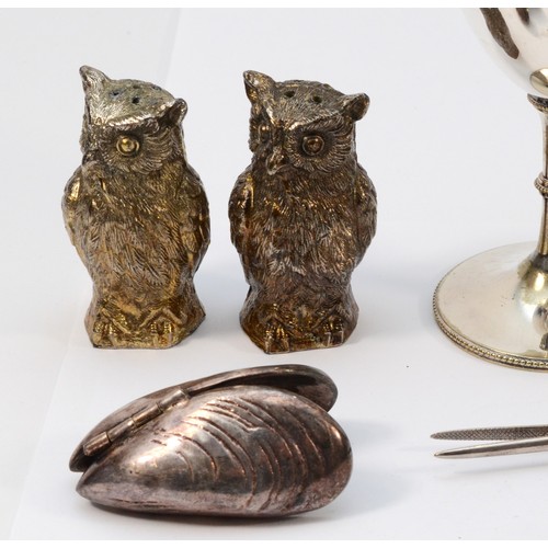 488 - An EPNS owl salt and pepper, 7cm, a muscle clamp and other plated wares