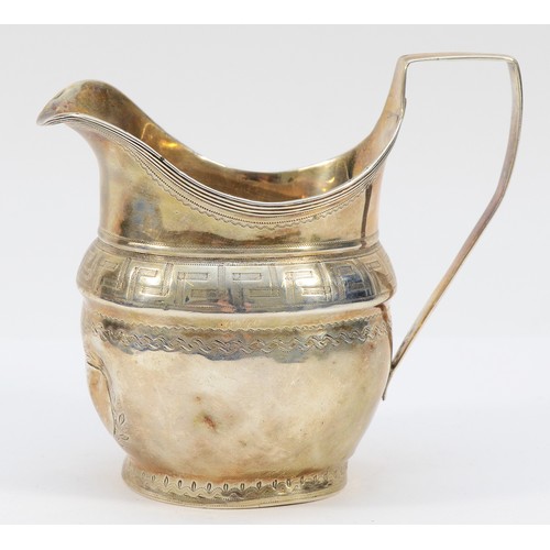 496 - A George III silver milk jug, London 1805, bright cut decoration, applied plaque over initials, 10cm... 