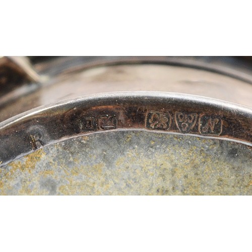 507 - A circular silver and tortoiseshell trinket box, Chester 1914, with velvet liner, raised on four fee... 