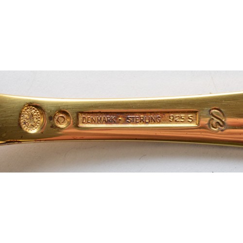 544 - Annelise Bjorner for Georg Jensen, a silver gilt and enamel 2001 year spoon, 14.5cm, 44gm, case