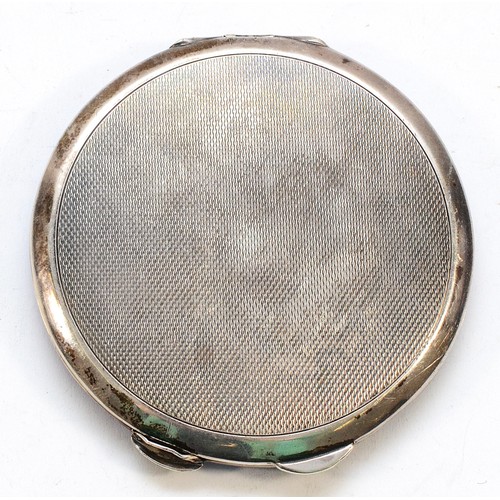 557 - A silver and guilloche enamel circular compact, Birmingham 1936, mirror but no powder, diameter 8cm,... 