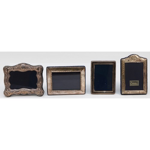 564 - A silver embossed photograph frame, Sheffield 1997, 12x9.5cm, together with a rectangular silver fra... 