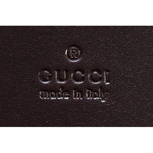 593 - Gucci, a stainless steel travelling alarm clock, model 200, leather case, working order and original... 