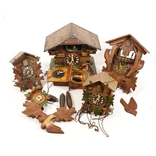 684 - A collection of five mid-twentieth century Black Forest cuckoo clocks, having single and twin train ... 