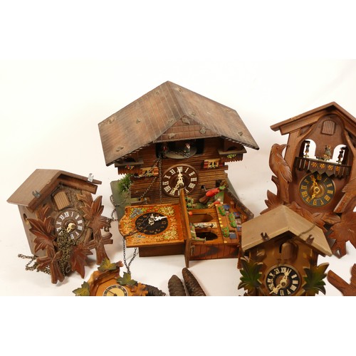 684 - A collection of five mid-twentieth century Black Forest cuckoo clocks, having single and twin train ... 