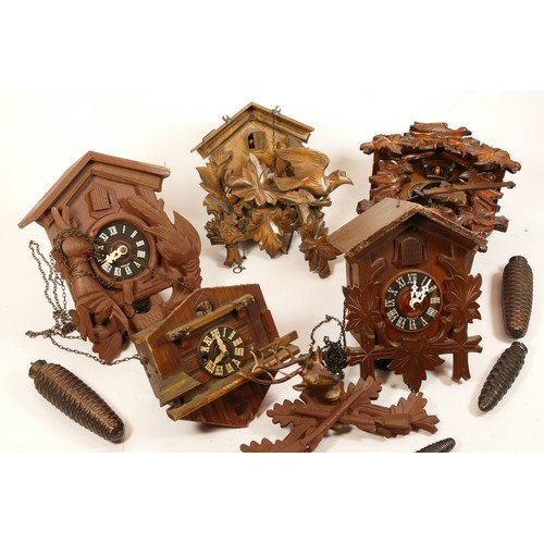 685 - A collection of five mid-twentieth century Black Forest cuckoo clocks, having single and twin train ... 