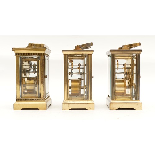 702 - Three mid to late twentieth century brass carriage clocks, having enamelled dials and featuring Roma... 