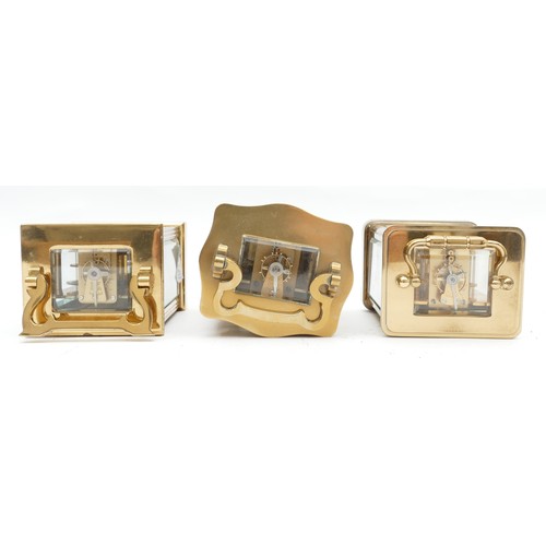 703 - Three mid to late twentieth century brass carriage clocks, having enamelled dials and featuring Roma... 