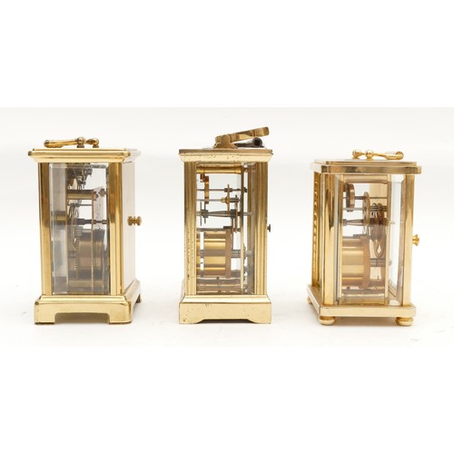 704 - Three mid to late twentieth century brass carriage clocks, having enamelled dials and featuring Roma... 