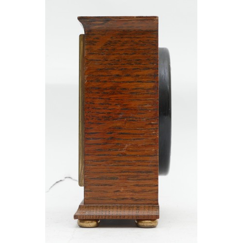 714 - An Elliott of London bracket clock, oak-cased with a silvered dial featuring Roman Numerals, and hou... 