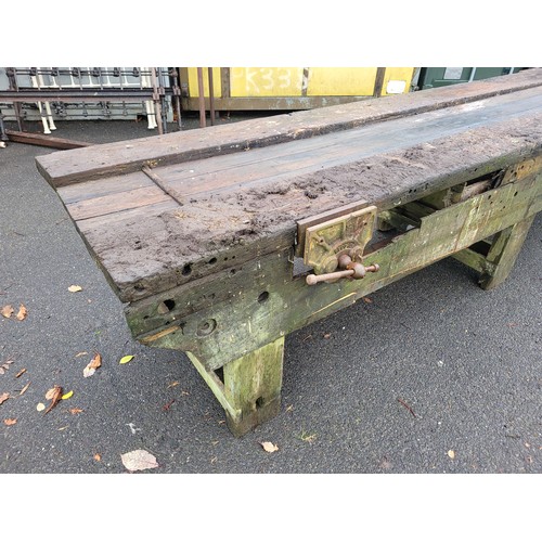 727 - A substantial bespoke pitch pine workbench, having attached vices to either ends, L355, H77, D80cm.