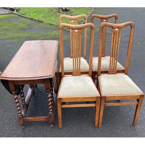 737 - A group of oak furniture pieces, to include a drop leaf dining table with four dining chairs, a nest... 