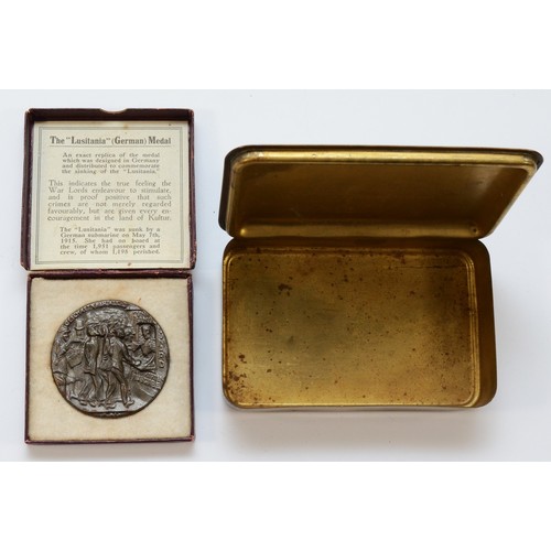 403 - A WWI brass Queen Mary 1914 Christmas tin, 13 x 8.5cm, together with a Replica Lusitania Medal, in o... 