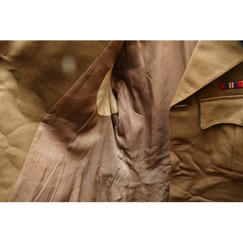 422 - Two British military uniforms, including a WWII captains tunic, 87 x 49cm with a post war tunic and ... 