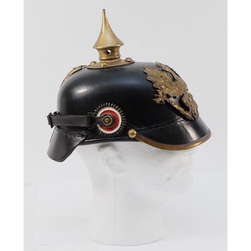 425 - A WWI German/Prussian Imperial Spiked Pickelhaube helmet, the brass front displaying the spread-wing... 