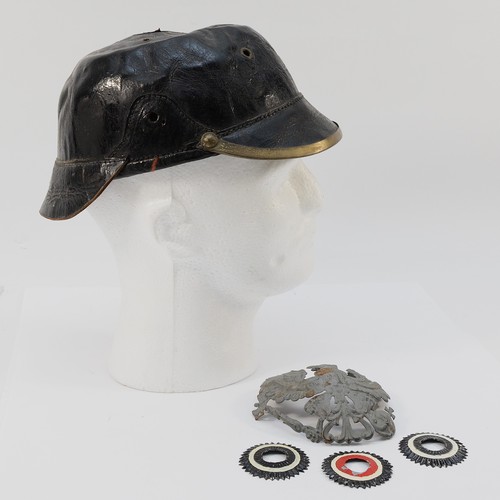 426 - A WWI German/Prussian Pickelhaube helmet, missing its spiked top and leather chin strap, with a trio... 