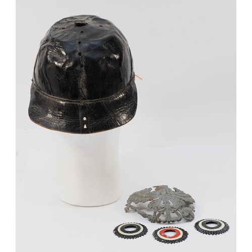 426 - A WWI German/Prussian Pickelhaube helmet, missing its spiked top and leather chin strap, with a trio... 