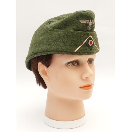 428 - A WWII replica German Third Reich Infantry M34 cap, embroidered with the eagle with swastika at the ... 