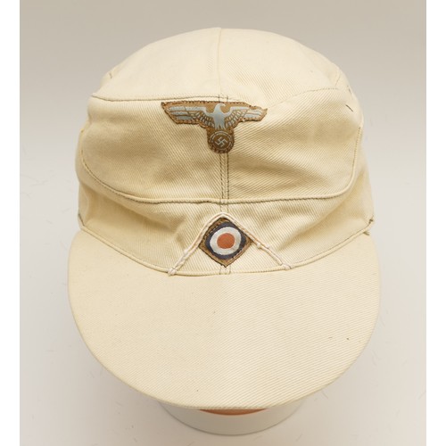 444 - WWII German Third Reich M41 Tropical cap, embroidered with the eagle with swastika insignia on the f... 