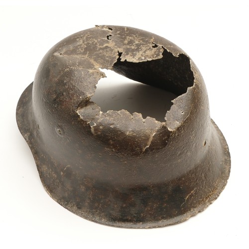 451 - WWII German battle scarred M42 helmet, severely damaged and missing its interior leather lining.
Thi... 