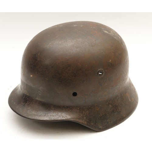 461 - A German WWII steel M42 helmet, stamped DN54, NS64, no liner, 8mm hole to the rear.
This is a very s... 