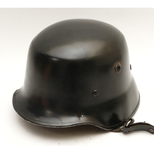 462 - A WWII German Fireman's helmet, with original leather lining and straps, stamped 2437, 03.
This is a... 